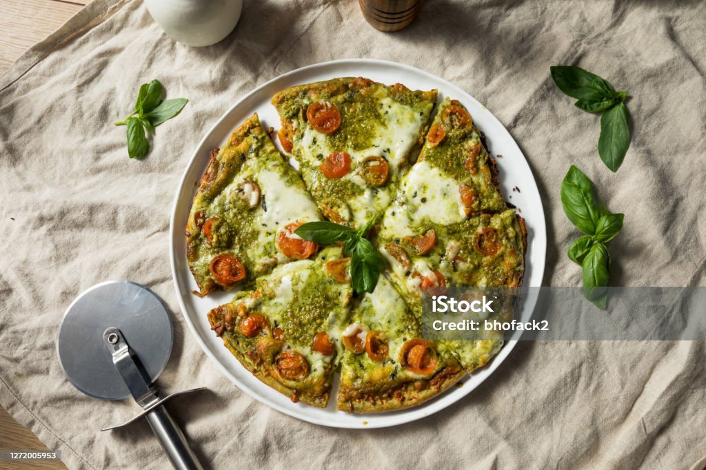 Homemade Green Pesto Pizza with Mozzarella and Tomatoes